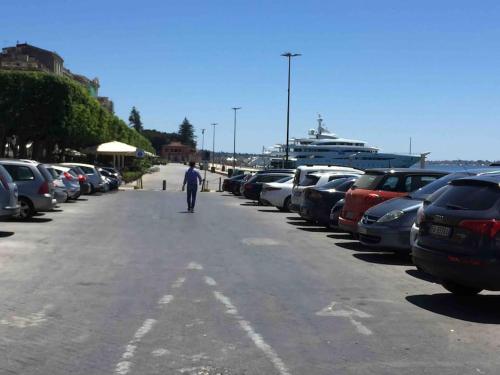 a man walking down the street in a parking lot at Casa Clio in Syracuse