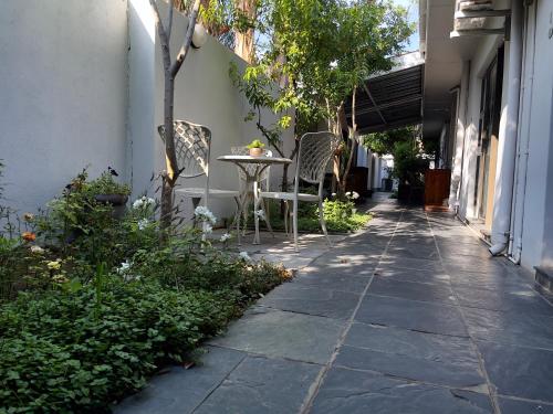 a patio with a table and chairs on a sidewalk at Border Close Guesthouse in Upington
