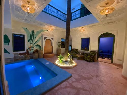 a large living room with a large swimming pool at Riad Celia in Marrakech