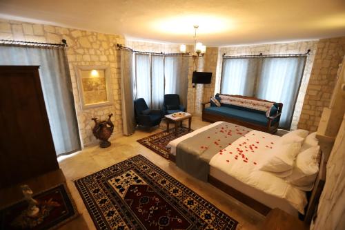 a bedroom with a bed and a couch in a room at Castle Panorama House in Nevsehir