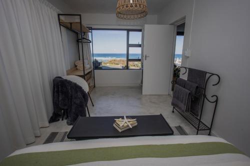 a bedroom with a bed and a table with a candle on it at HIGH LEVEL 26 in Agulhas