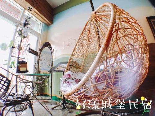 a basket swing in a room with a mirror at Hi Young Castle in Hengchun