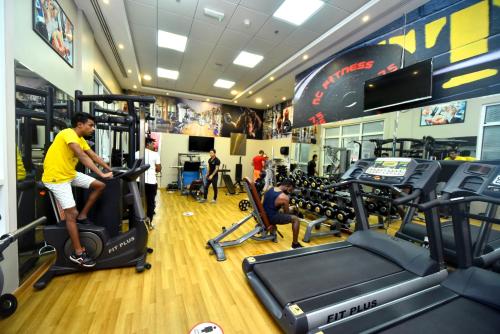 a man exercising on a treadmill in a gym at Emirates Stars Hotel Apartments Dubai in Dubai