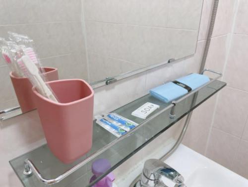 a glass shelf in a bathroom with a mirror at Ellen House in Seoul