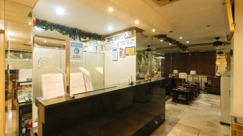 a display case in a room with a table at Peace Hotel by RedDoorz in Manila