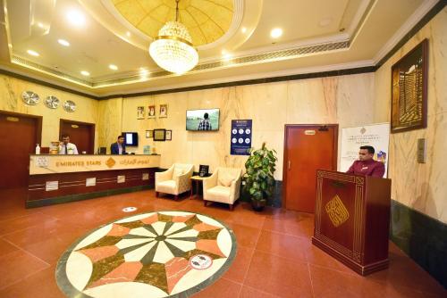 a lobby of a hotel with a reception desk at Emirates Stars Hotel Apartments Sharjah in Sharjah