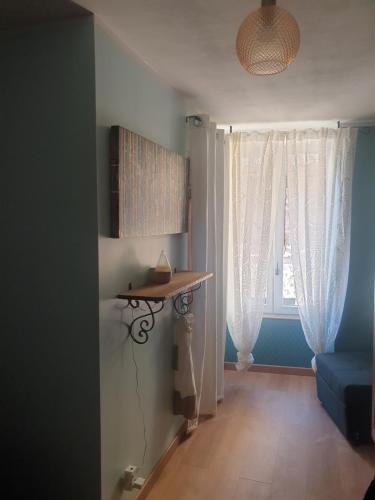 a living room with a table and a window at 4 safraniers in Sillans-la Cascade