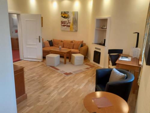 a living room with a couch and a table at Schlosshotel Domäne Walberberg in Bornheim