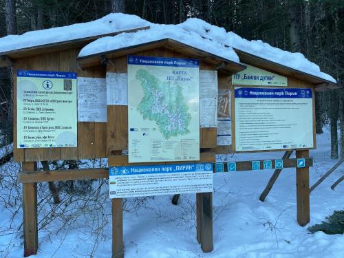 a sign with snow on top of it at Pirin Dream View Apartments in Razlog