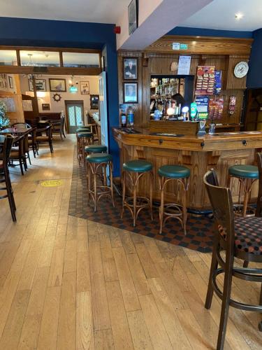 a bar in a restaurant with chairs and tables at The Acres B&B in Killala