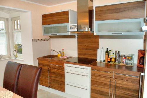 a kitchen with wooden cabinets and a counter top at Mar Baltico in Zingst
