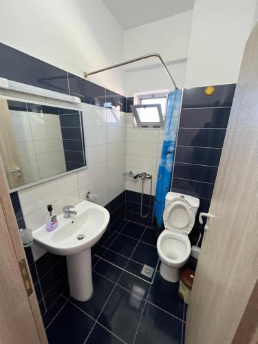 a bathroom with a sink and a toilet at Hotel Irini in Sarandë