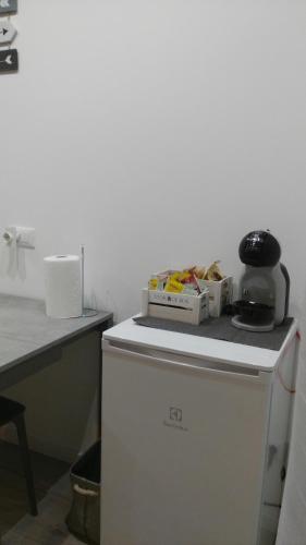 a small white refrigerator with a box on top of it at Corte Disore in Rivolto