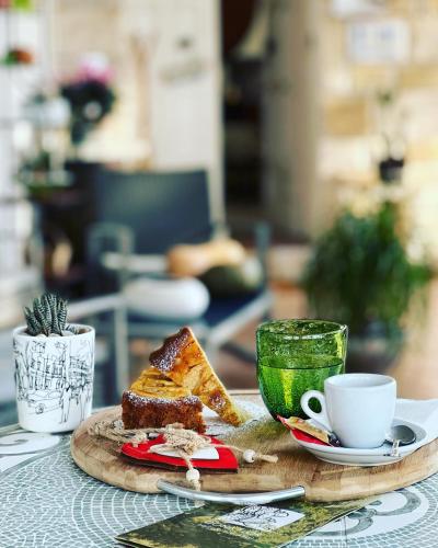 a table with a plate of food and a cup of coffee at B&B DOÑA FLOR in Parabita