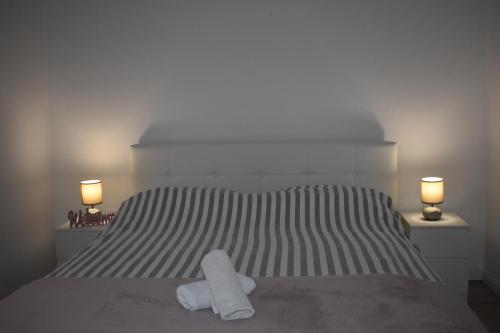 a bedroom with a bed with two towels on it at House Burić in Otočac