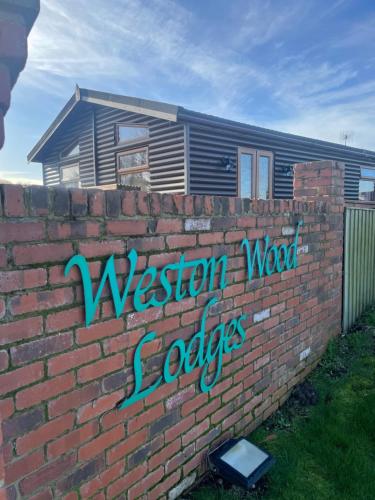 a brick wall with the words wisdomweapon experts painted on it at #3 Delightful 3 bedroom lodge - holiday home, No Hot tub 