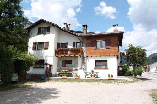 a large white house with a balcony on a street at Casa Caliman in Santa Caterina