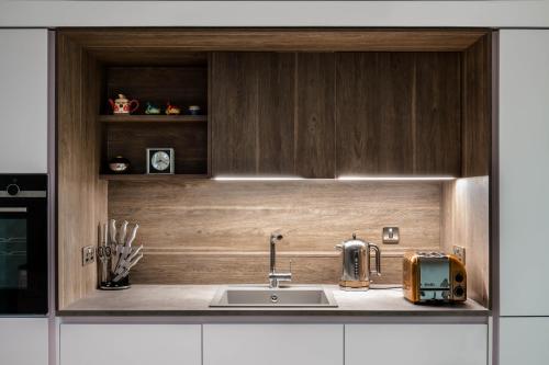 a kitchen counter with a sink and a toaster at No. 5 Warriston, Canonmills Luxury Apartment in Edinburgh