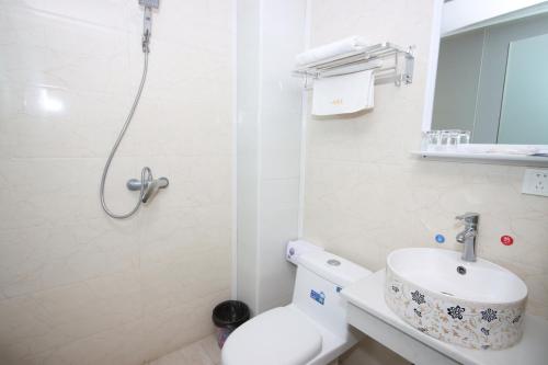 La salle de bains est pourvue d'une douche, de toilettes et d'un lavabo. dans l'établissement One Meter Sunshine Hotel Xi'an Xianyang International Airport Flagship Store, à Xianyang