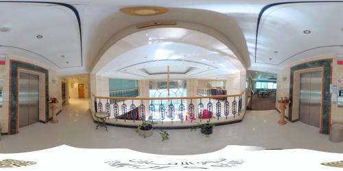 a hallway with a spiral staircase in a building at Nejoum Al Emarat in Sharjah