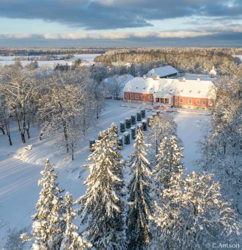 an aerial view of a building with snow covered trees at Sagadi Manor Hotel in Sagadi