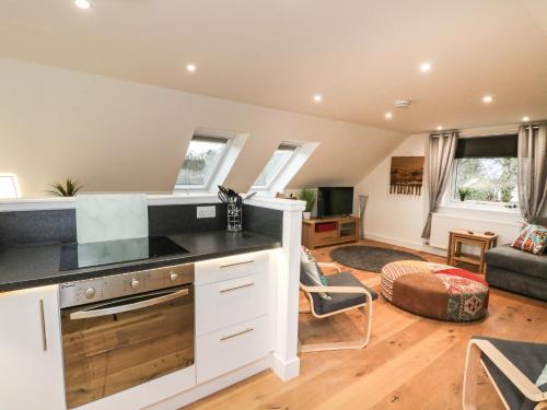 a kitchen with a counter top and a living room at Taorbeag at Taormina in Fort William