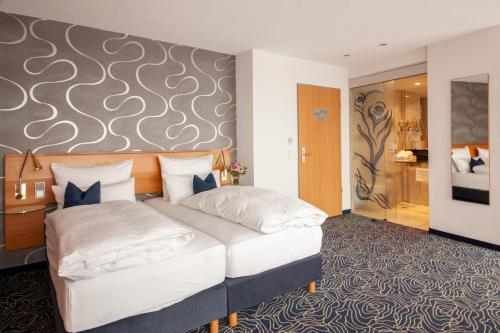 a hotel room with a bed and a wall at Hotel Seehof Haltern am See in Haltern