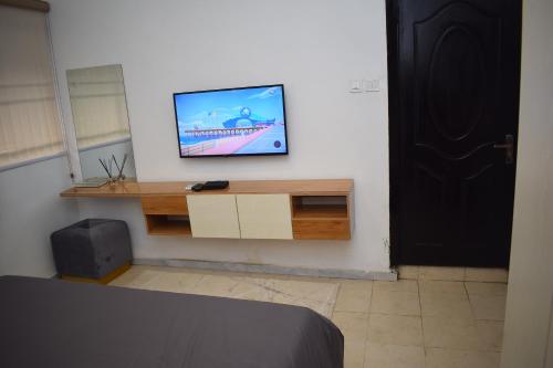 a tv sitting on a wall in a room at Luxury Apartments in Lagos