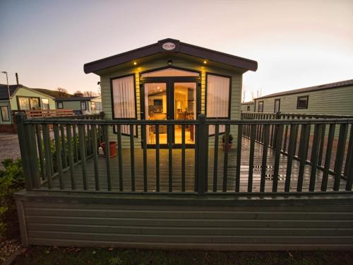a small house with a railing on a porch at Bayfield in Lamplugh