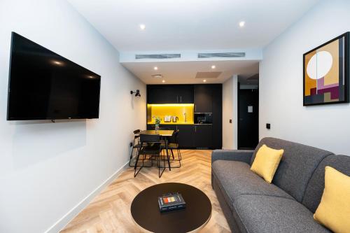 a living room with a couch and a table at Staycity Aparthotels Dublin Tivoli in Dublin