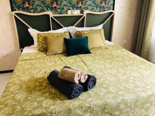 a bed with towels and pillows on it at Chambao Maldives in Guraidhoo