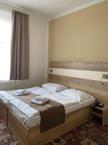 a bedroom with a bed with two towels on it at City Centre in Prague