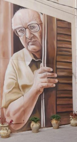 a painting of a man with glasses and a tie at Villa Azzurra Scale of the Turks in Realmonte