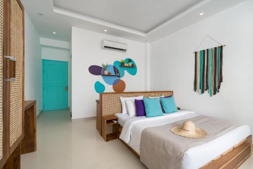 a bedroom with a bed with a hat on it at Outpost Weligama Beachfront in Weligama