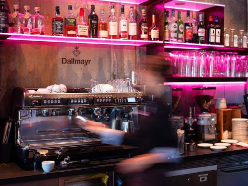 a kitchen with a bar with bottles of alcohol at Altes Stahlwerk Business & Lifestyle Hotel in Neumünster