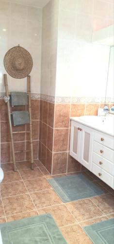 a bathroom with a sink and a chair in it at La Dolce Vita Opio in Opio