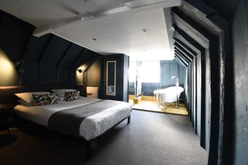 a bedroom with a large bed and a large window at Whitehouse Rye in Rye