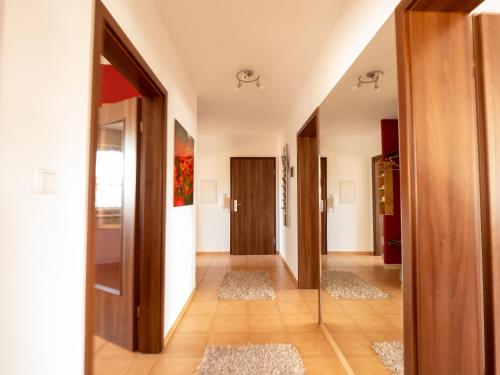 a hallway with wooden doors and rugs at Fewo Papst Nordborchen in Nordborchen