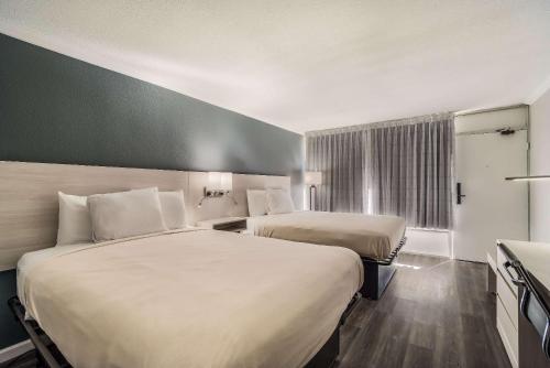 a hotel room with two beds and a window at MainStay Suites Florence - Darlington in Florence