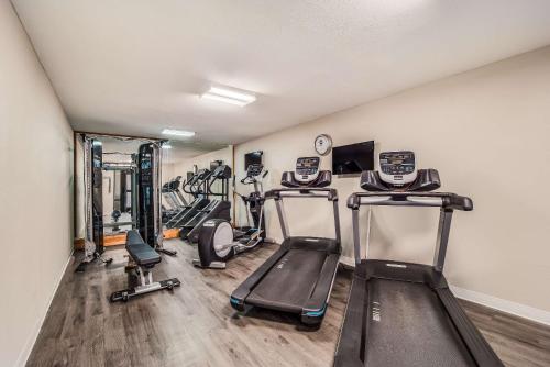 a gym with several treadmills and elliptical machines at MainStay Suites Florence - Darlington in Florence