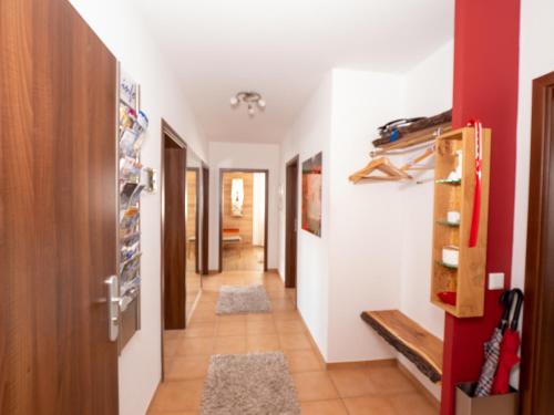 a hallway with red and white walls and a red door at Fewo Papst Nordborchen in Nordborchen