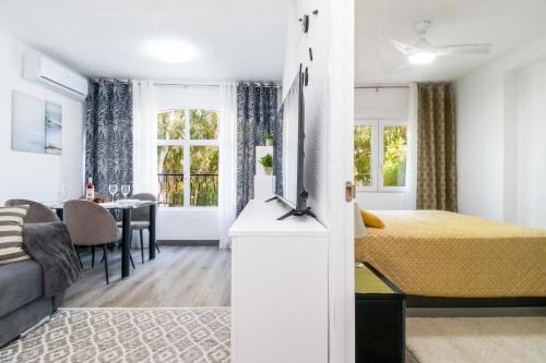 a bedroom with a bed and a dining room at Espanatour VIOLETAS in Orihuela
