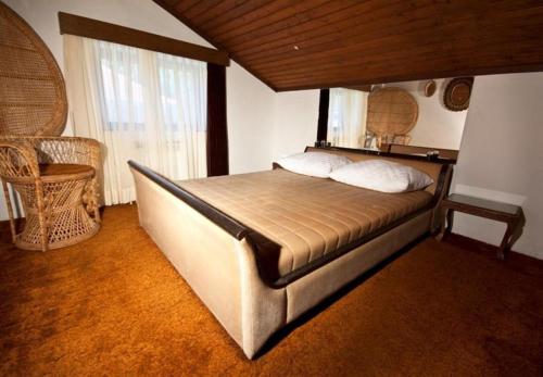 a bedroom with a large bed in a room at Rooms Branka - colorful in Križevci