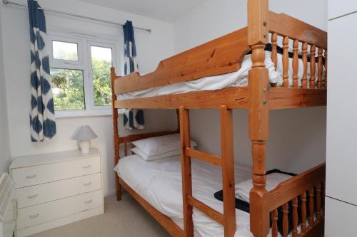 a bedroom with bunk beds in a house at Holiday Bungalow, short drive to 7 Beaches! in Saint Merryn