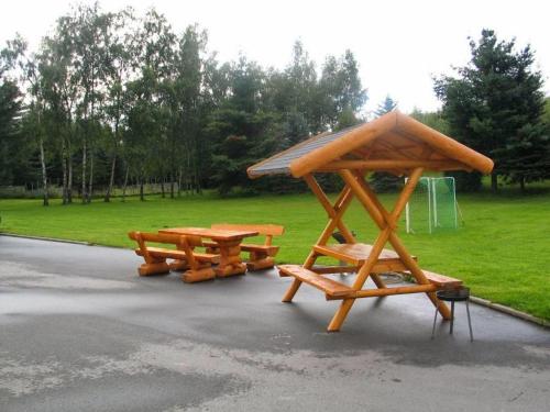 two picnic tables and a gazebo in a park at Pension Pöhlbergblick Annaberg in Annaberg-Buchholz