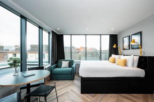 a hotel room with a bed and a table and a chair at Staycity Aparthotels Dublin Tivoli in Dublin
