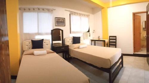 Voodi või voodid majutusasutuse Amax Inn Cebu toas