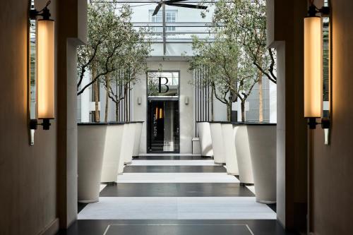 a hallway with trees on the sides of a building at H15 Boutique Hotel in Warsaw