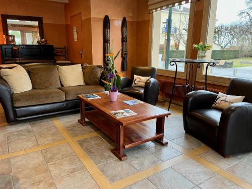 a living room with couches and a coffee table at Hôtel L'Iroko The Originals City in Aix-les-Bains