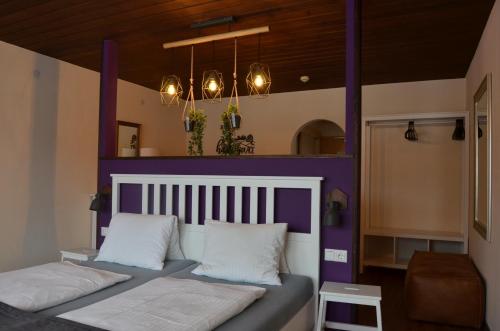 سرير أو أسرّة في غرفة في Dahoam by Sarina - Rooms & Suites